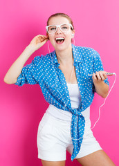 Wall Mural - Happy young woman with earbuds