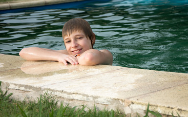  happy boy in swimming pool