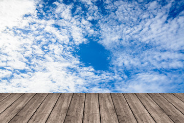 Wall Mural - Wooden table or terrace on Deep blue sky and clouds. Space for y