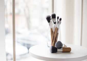 Professional makeup brushes in a glass