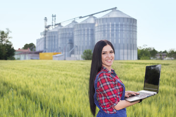 Wall Mural - Farmer girl in barley field