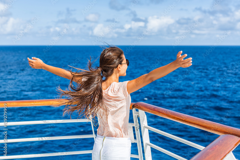 Cruise ship vacation woman enjoying travel vacation having fun at sea. Free carefree happy girl looking at ocean with open arms in freedom pose. - obrazy, fototapety, plakaty 