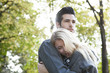 © PhotoAlto - Couple embracing outdoors