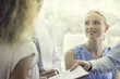 © PhotoAlto - Associate handing colleague document