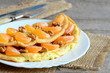 Sweet and tasty omelet on a plate. Homemade fried omelet stuffed with fresh mandarins and raw walnuts, fork, knife, burlap textile on old wooden table. Easy breakfast omelette recipe. Closeup 