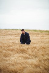 Poster - Farmer checking his crops in the field