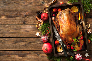 Wall Mural - Christmas roast duck with apples and oranges on baking tray