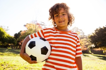 Portrait of smiling boy holding soccer ball 