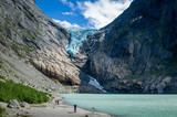 Fototapeta  - Tourists at Briksdalsbreen glacier viewpoint, Norway.