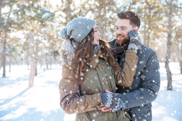 Couple looking at each other in winter park