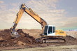Excavator digging and moving earth at construction site