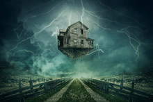 Rapture Surreal Concept. Ghost House Ripped From The Ground Flying Above A Country Road In A Stormy Day With Lightnings In The Sky.