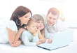 © ASDF - family looking into the laptop enthusiastically
