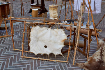 Village fair vintage Handicrafts. Pottery, leather and wooden objects on table.