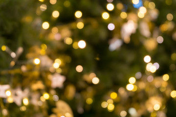 christmas tree bokeh light in green yellow golden color, holiday abstract background, blur defocused