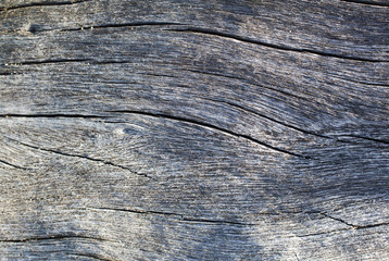 Grey timber board with weathered crack lines.