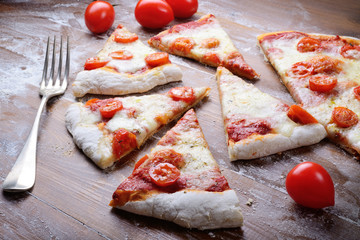 Wall Mural - Pizza slices, tomato, mozzarella and cherry tomatoes