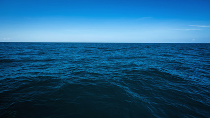 the vast ocean in the winter, dark and deep ocean with blue sky