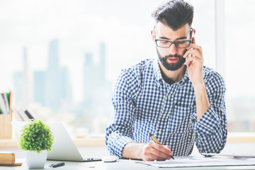 Wall Mural - Guy on phone doing paperwork