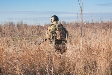 Wall Mural - Airsoft Soldiers in posing with rifle back picture