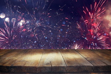 Wall Mural - Empty wooden table in front of fireworks background