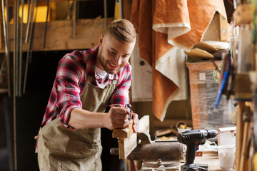 Wall Mural - carpenter working with plane and wood at workshop