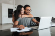© Drobot Dean - Happy loving couple using laptop and analyzing their finances