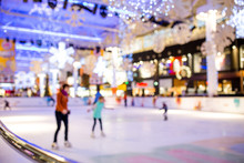 Blurred Abstract Defocus Background Of People Indoor Ice Skating In Modern Shopping Mall, At Christmas Holiday.