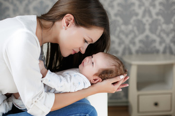 portrait of mother and child,beautiful mom,brunette with long straight hair,dressed in a white shirt