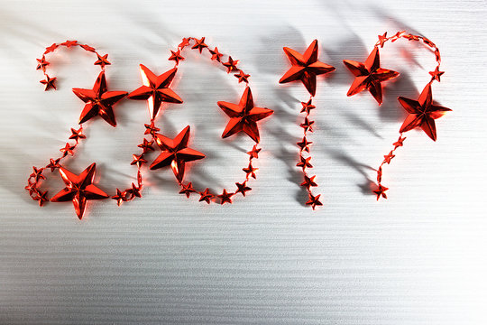 Christmas inscription 2017 red stars on white wooden background