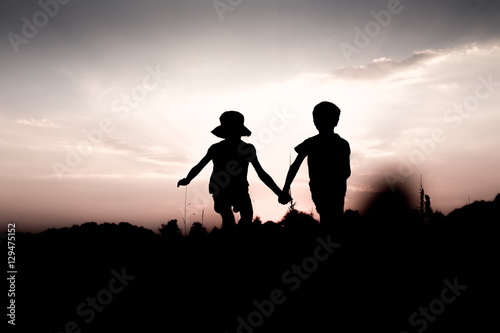 Silhouettes Of Kids Jumping Off A Hill At Sunset Little Boy And Girl Jump High Holding Hands Brother And Sister Having Fun In Summer Friendship Freedom Concept Stock Photo Adobe Stock