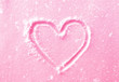 hand drawn heart shape in the fresh pink snow with snowfall effe