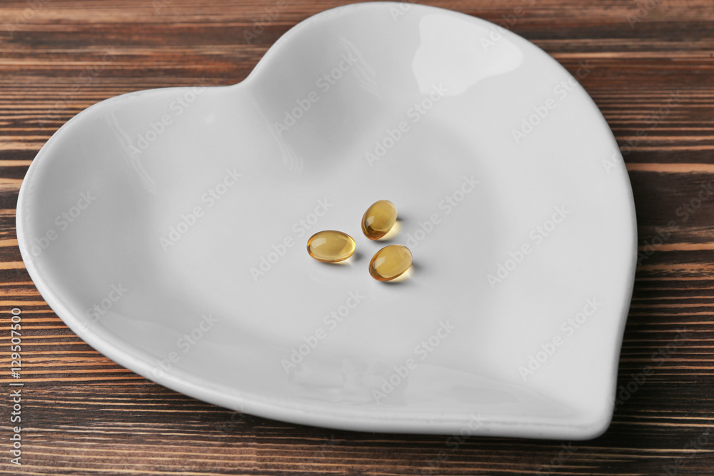 Fish oil capsules on plate