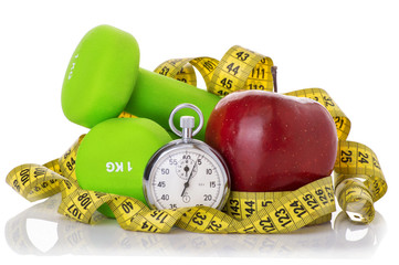 Two dumbbells, red apple, measuring tape.