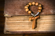 Tau, wooden cross symbol of St. Francis of Assisi with rosary bead and Holy Bible