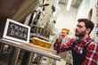 © WavebreakMediaMicro - Manufacturer examining beer in brewery
