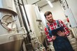 © WavebreakMediaMicro - Manufacturer holding writing pad in brewery