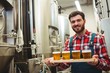 © WavebreakMediaMicro - Manufacturer holding beer glasses in brewery