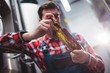 © WavebreakMediaMicro - Manufacturer examining beer bottle at brewery