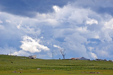 Wall Mural - Ominous storm clouds approaching over rolling green hills and farmland in the New South Wales countryside, Australia