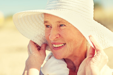 Sticker - happy senior woman in sun hat on summer beach