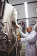 © WavebreakMediaMicro - Male manufacturer examining beer at brewery