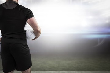 Poster - Composite image of rugby player holding the ball