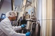 © WavebreakMediaMicro - Manufacturer working at storage tanks in brewery
