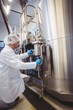 © WavebreakMediaMicro - Manufacturer working at storage tanks in brewery