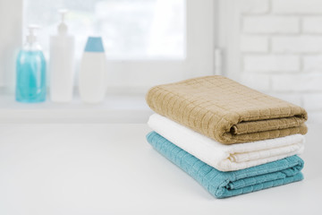 Wall Mural - Bath towel pile on wood over defocused bathroom windowsill background