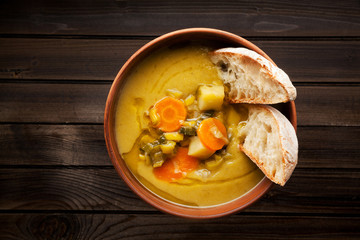  Italian traditional minestrone soup on a wooden table