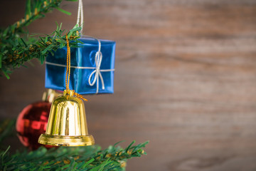 Poster - Christmas ornaments bell hang on Christmas Tree have space wood background.