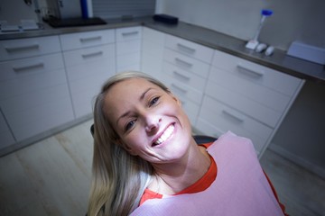 Female patient sitting on dentist chair