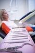 © WavebreakMediaMicro - Woman relaxing on dentist chair with dental tools on foreground